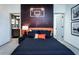 Spacious bedroom with basketball theme decor, dark wood desk, and a plush bed at 4720 Montane St, Cumming, GA 30028