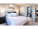 Bedroom features plush bedding, sleek black nightstand, and an en-suite bathroom at 4720 Montane St, Cumming, GA 30028