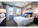 Cozy bedroom features soft lighting, plush bedding, and tranquil outdoor views at 4720 Montane St, Cumming, GA 30028