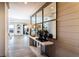 Inviting hallway showcasing modern console table and mirror, leading to a bright living area with outdoor access at 4720 Montane St, Cumming, GA 30028