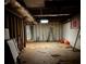 Unfinished basement space with exposed ceiling, concrete block walls, and ladder at 5317 Kings Hwy, Douglasville, GA 30135