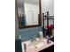 A bathroom features a wood-framed mirror and a pink marble-esque sink countertop, ready for personalization at 5317 Kings Hwy, Douglasville, GA 30135