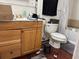 Functional bathroom with a wood vanity, toilet, tub, and shower combo, plus essential fixtures at 5317 Kings Hwy, Douglasville, GA 30135