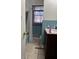 Bathroom with blue tiled walls, a sink vanity, tub, and shower combo, offering essential amenities at 5317 Kings Hwy, Douglasville, GA 30135