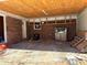 Interior view of an open carport with unfinished ceiling and miscellaneous items at 5317 Kings Hwy, Douglasville, GA 30135