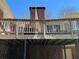 View of the brick house showing the second-story deck needing repair, with the yard below at 5317 Kings Hwy, Douglasville, GA 30135