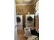 Features a white washer and dryer set with overhead shelving, offering functionality and storage options at 5317 Kings Hwy, Douglasville, GA 30135