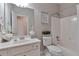 A well-lit bathroom features white fixtures and a shower-tub combination at 5613 Lancashire Ln, Cumming, GA 30041