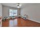 Spacious bedroom with hardwood floors, large window, and plenty of natural light at 5613 Lancashire Ln, Cumming, GA 30041