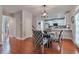 Cozy dining area with stylish chairs and a view into the modern white kitchen at 5613 Lancashire Ln, Cumming, GA 30041