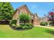Charming two-story home featuring manicured landscaping and a welcoming front porch at 5613 Lancashire Ln, Cumming, GA 30041