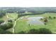 Scenic golf course showcasing a tranquil pond with a fountain and well-maintained fairways at 5613 Lancashire Ln, Cumming, GA 30041
