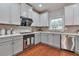 Updated kitchen with stainless steel appliances, granite countertops, and ample cabinet space at 5613 Lancashire Ln, Cumming, GA 30041