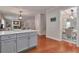 Open-concept kitchen with island and view to living room and formal dining space at 5613 Lancashire Ln, Cumming, GA 30041