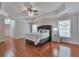 Spacious main bedroom with tray ceiling, hardwood floors, and a large window at 5613 Lancashire Ln, Cumming, GA 30041
