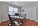 Bright office space with a white desk, modern seating, and a large window for natural light at 5613 Lancashire Ln, Cumming, GA 30041