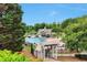 An inviting pool area featuring clear blue water, lounge chairs, umbrellas, and a snack bar at 5613 Lancashire Ln, Cumming, GA 30041