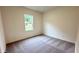 Bright bedroom featuring neutral walls, plush carpet, and a window offering natural light at 60 Sonoma Drive, Dallas, GA 30157