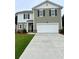 Charming two-story home featuring a well-manicured lawn, two-car garage and modern architectural details at 60 Sonoma Drive, Dallas, GA 30157