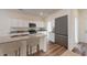 Bright kitchen featuring stainless steel appliances, granite counters, island with seating and hardwood floors at 60 Sonoma Drive, Dallas, GA 30157