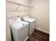 Convenient laundry room with washer, dryer, and wire shelving at 60 Sonoma Drive, Dallas, GA 30157