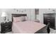 Comfortable bedroom with a full sized bed, a nightstand, and neutral tones at 6005 Pine Bluff Pl, Conyers, GA 30013
