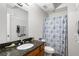 Well-lit bathroom featuring granite countertop, and a shower with a patterned curtain at 1031 State Nw St # 106, Atlanta, GA 30318