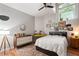 Comfortable bedroom featuring hardwood floors, a bright window and warm decor at 1031 State Nw St # 106, Atlanta, GA 30318