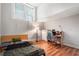 Bright bedroom featuring hardwood floors, a window with blinds, and desk area at 1031 State Nw St # 106, Atlanta, GA 30318