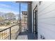A modern exterior balcony overlooking a neighborhood featuring black metal railings and wood-style flooring at 1145 Kirkwood Se Ave # 14, Atlanta, GA 30316