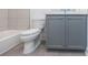 Bathroom features a white toilet, gray vanity, and gray tiled bathtub at 1145 Kirkwood Se Ave # 14, Atlanta, GA 30316