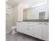 Bathroom features a shower with glass door and double vanity with gray countertop at 1145 Kirkwood Se Ave # 14, Atlanta, GA 30316
