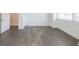 Empty bedroom featuring dark hardwood floors, white walls, and a large window at 1145 Kirkwood Se Ave # 14, Atlanta, GA 30316