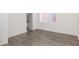 Empty bedroom featuring dark hardwood floors, white walls, and a window at 1145 Kirkwood Se Ave # 14, Atlanta, GA 30316