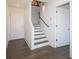 Bright entryway featuring hardwood floors, stairs with modern railing, and a convenient storage closet at 1145 Kirkwood Se Ave # 14, Atlanta, GA 30316