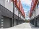 A row of modern townhomes with red accents and attached garages, seen from street at 1145 Kirkwood Se Ave # 14, Atlanta, GA 30316