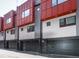 Modern townhome row with attached garages and a striking red and grey facade at 1145 Kirkwood Se Ave # 14, Atlanta, GA 30316