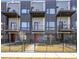 Modern townhouse featuring balconies, metal accents, and a well-maintained front yard with fence at 1145 Kirkwood Se Ave # 14, Atlanta, GA 30316