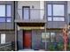 Contemporary townhouse showcasing dark brick, a private balcony, and an inviting red front door at 1145 Kirkwood Se Ave # 14, Atlanta, GA 30316