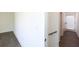 Hallway with wood flooring, a staircase with a handrail, and access to a room with a glass-paneled door at 1145 Kirkwood Se Ave # 14, Atlanta, GA 30316