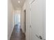 Hallway view featuring wood floors, neutral walls, and doors, leading to multiple rooms within the home at 1145 Kirkwood Se Ave # 14, Atlanta, GA 30316