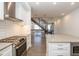 Eat-in kitchen with stainless steel appliances, subway tile backsplash, stone countertops, and an open staircase at 1145 Kirkwood Se Ave # 14, Atlanta, GA 30316