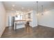 Modern open-concept kitchen with stainless steel appliances, white cabinets, kitchen island, and stylish pendant lighting at 1145 Kirkwood Se Ave # 14, Atlanta, GA 30316