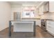 Modern kitchen with stainless steel appliances, white cabinets, stone countertops, and island in an open layout at 1145 Kirkwood Se Ave # 14, Atlanta, GA 30316