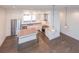 Modern open-concept kitchen with stainless steel appliances, white cabinets, kitchen island, and stylish pendant lighting at 1145 Kirkwood Se Ave # 14, Atlanta, GA 30316