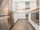 This kitchen features white cabinets, stainless steel appliances, subway tile backsplash, and wood flooring at 1145 Kirkwood Se Ave # 14, Atlanta, GA 30316