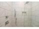 Elegant shower with marble-patterned tile, rainfall showerhead, and handheld sprayer at 1145 Kirkwood Se Ave # 14, Atlanta, GA 30316