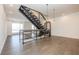 Modern staircase with metal railings and wood accents, illuminated by stylish pendant lights at 1145 Kirkwood Se Ave # 14, Atlanta, GA 30316
