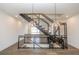 Modern staircase with metal railings and wood accents, illuminated by stylish pendant lights at 1145 Kirkwood Se Ave # 14, Atlanta, GA 30316