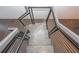 A modern staircase with gray steps, a black metal railing, and cable detail surrounded by wood floors at 1145 Kirkwood Se Ave # 14, Atlanta, GA 30316